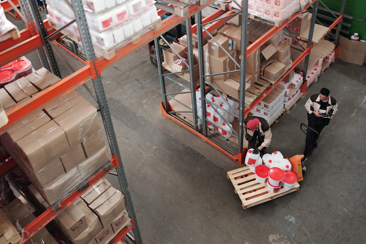 a top view of 2 person working inside a warehouse in logistics